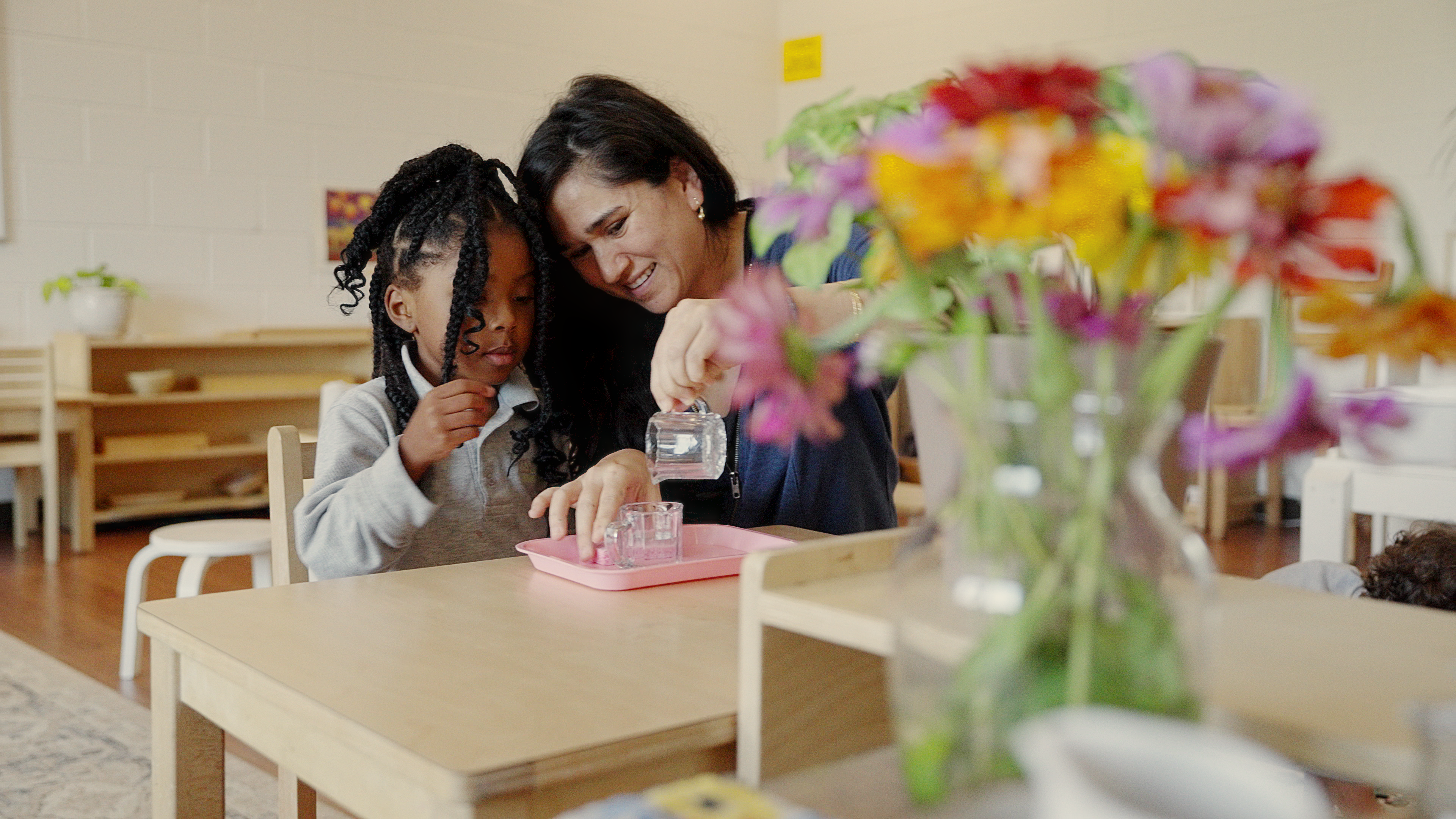 Teacher and student at classroom desk